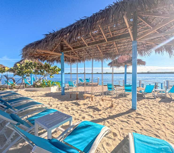 Nassau: Beach Day at SunCay incl. Lunch - Boat Tour - SunCay beach setup: shade, lounge chairs, pools, and water toys